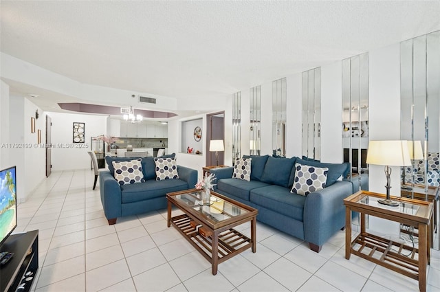9341 Collins Ave Unit 1204, Surfside, FL 33154 - living room featuring light tile patterned floors and a textured ceiling