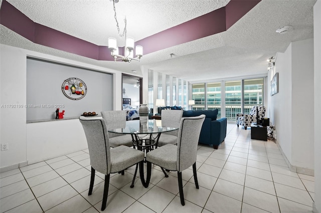 9341 Collins Ave Unit 1204, Surfside, FL 33154 - dining space with a textured ceiling, a chandelier, and light tile patterned flooring