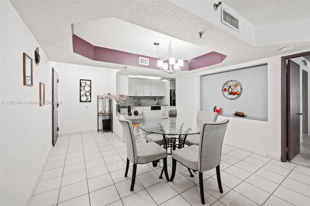 9341 Collins Ave Unit 1204, Surfside, FL 33154 - dining area with a textured ceiling, a chandelier, and light tile patterned floors