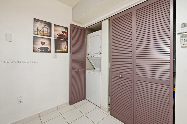 9341 Collins Ave Unit 1204, Surfside, FL 33154 - washroom with stacked washing machine and dryer and light tile patterned flooring