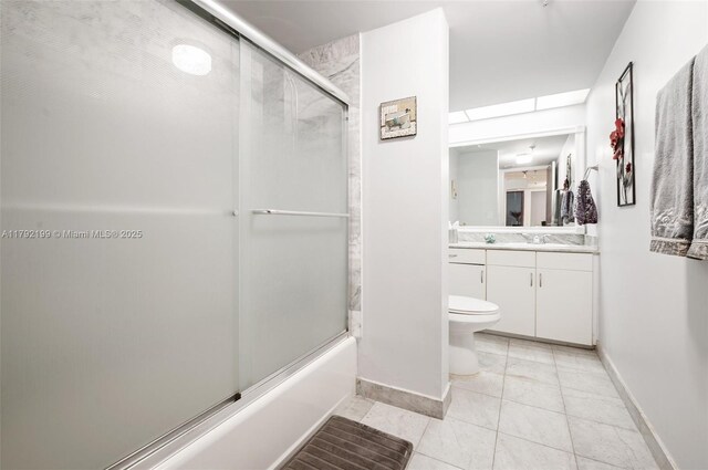 9341 Collins Ave Unit 1204, Surfside, FL 33154 - full bathroom with baseboards, vanity, tile patterned floors, toilet, and combined bath / shower with glass door