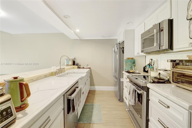 1033 NW 124th Ave, Pembroke Pines, FL 33026 - kitchen featuring appliances with stainless steel finishes, white cabinets, light stone counters, recessed lighting, and backsplash