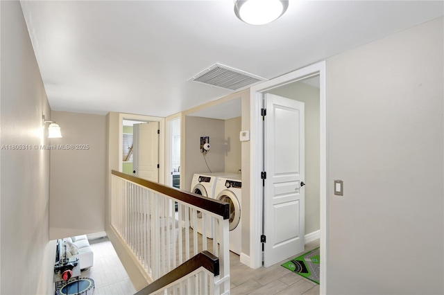 1033 NW 124th Ave, Pembroke Pines, FL 33026 - hall featuring washer and dryer, an upstairs landing, baseboards, and light wood-style floors