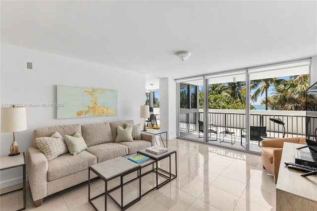 2655 Collins Ave Unit 411, Miami Beach, FL 33140 - living area featuring expansive windows, light tile patterned flooring, and baseboards