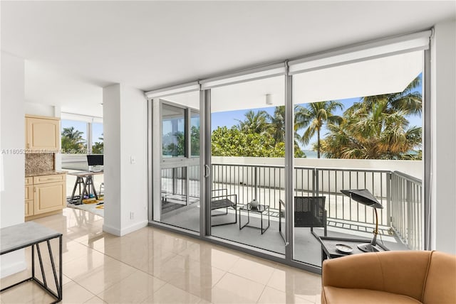 2655 Collins Ave Unit 411, Miami Beach, FL 33140 - entryway featuring light tile patterned floors, floor to ceiling windows, and baseboards