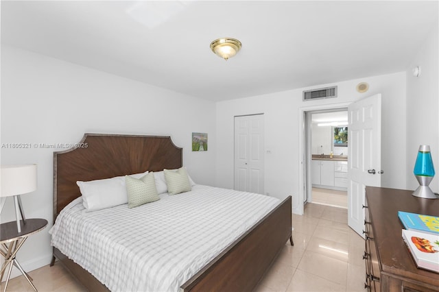 2655 Collins Ave Unit 411, Miami Beach, FL 33140 - bedroom with light tile patterned floors, a closet, and baseboards
