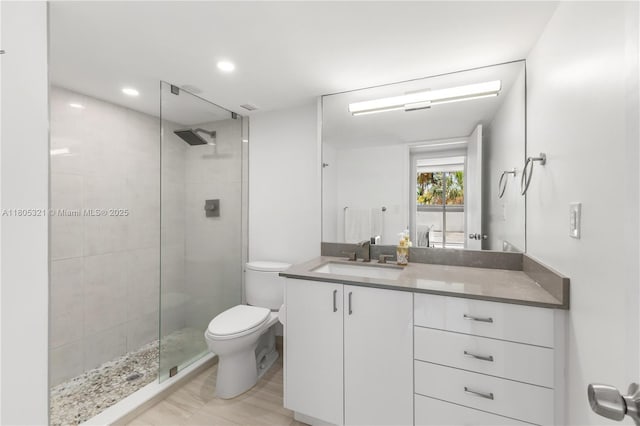 2655 Collins Ave Unit 411, Miami Beach, FL 33140 - bathroom featuring a shower stall, toilet, vanity, and recessed lighting