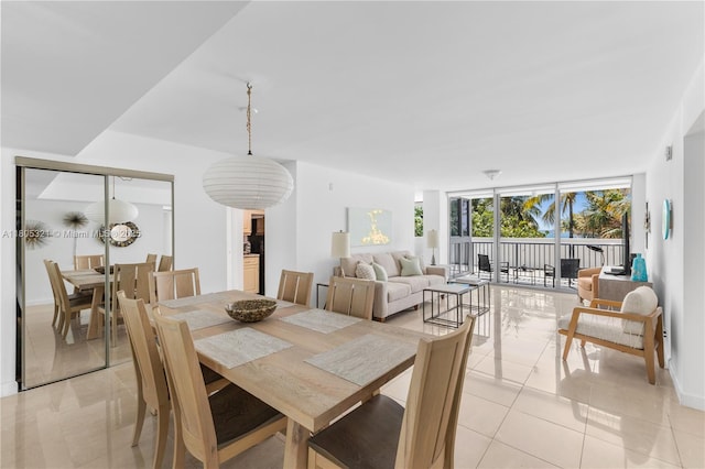 2655 Collins Ave Unit 411, Miami Beach, FL 33140 - dining space featuring light tile patterned flooring and expansive windows