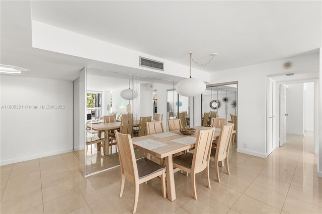 2655 Collins Ave Unit 411, Miami Beach, FL 33140 - dining area featuring light tile patterned floors and baseboards