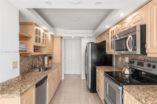 2655 Collins Ave Unit 411, Miami Beach, FL 33140 - kitchen featuring stainless steel appliances, a sink, decorative backsplash, light tile patterned floors, and glass insert cabinets