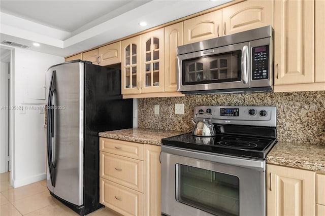 2655 Collins Ave Unit 411, Miami Beach, FL 33140 - kitchen featuring appliances with stainless steel finishes, light brown cabinets, light tile patterned floors, and recessed lighting