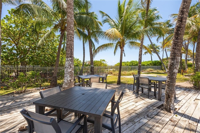 2655 Collins Ave Unit 411, Miami Beach, FL 33140 - wooden terrace with outdoor dining area and a fenced backyard