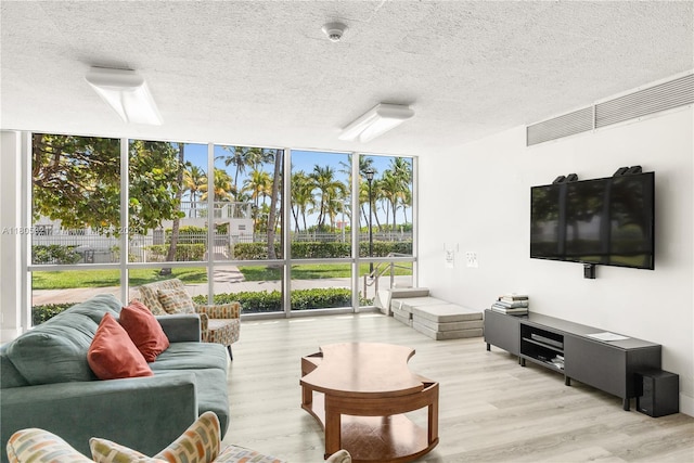 2655 Collins Ave Unit 411, Miami Beach, FL 33140 - living area featuring expansive windows, wood finished floors, and a textured ceiling