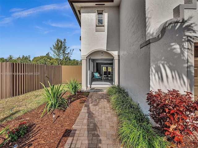 15066 SW 38th Ter, Miami, FL 33185 - view of exterior entry featuring stucco siding and fence