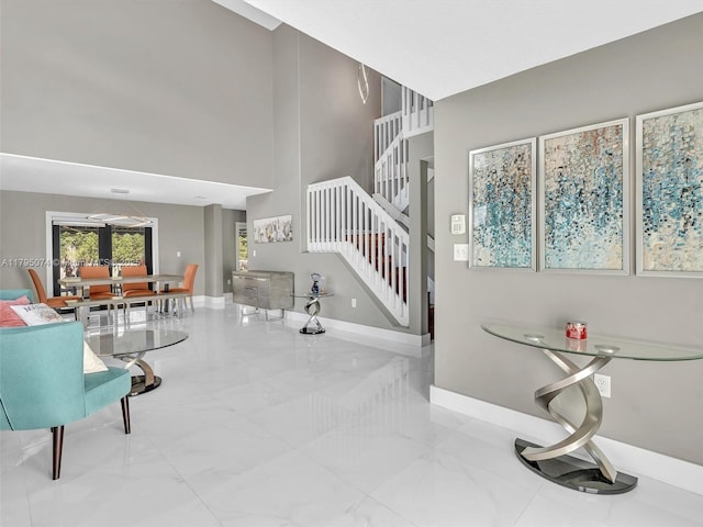 15066 SW 38th Ter, Miami, FL 33185 - living room with stairs, marble tiled flooring, baseboards, and a towering ceiling