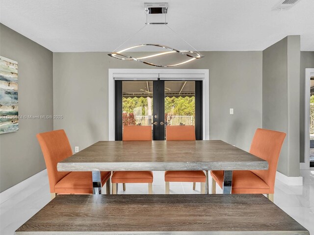 15066 SW 38th Ter, Miami, FL 33185 - dining space with french doors, a chandelier, and baseboards