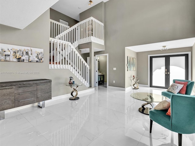 15066 SW 38th Ter, Miami, FL 33185 - living area featuring marble finish floors, french doors, a towering ceiling, stairs, and baseboards