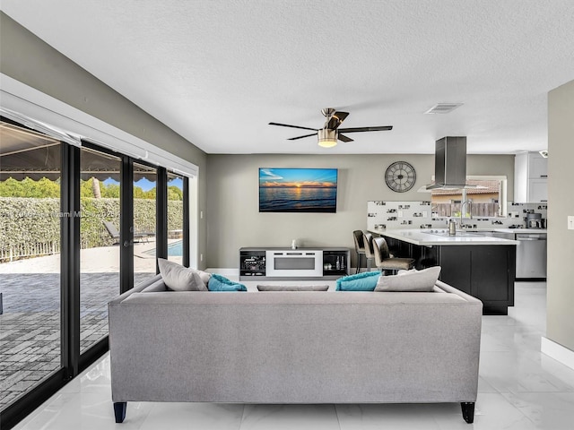 15066 SW 38th Ter, Miami, FL 33185 - living room featuring a textured ceiling, a ceiling fan, french doors, and light marble finish flooring