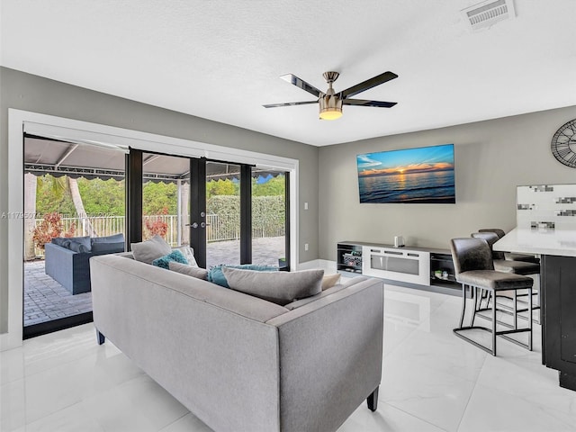 15066 SW 38th Ter, Miami, FL 33185 - living area featuring french doors, ceiling fan, light marble finish flooring, and a textured ceiling
