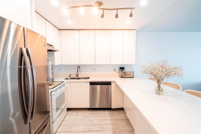 1817 S Ocean Dr Unit 0918, Hallandale Beach, FL 33009 - kitchen featuring appliances with stainless steel finishes, a sink, light countertops, white cabinets, and under cabinet range hood