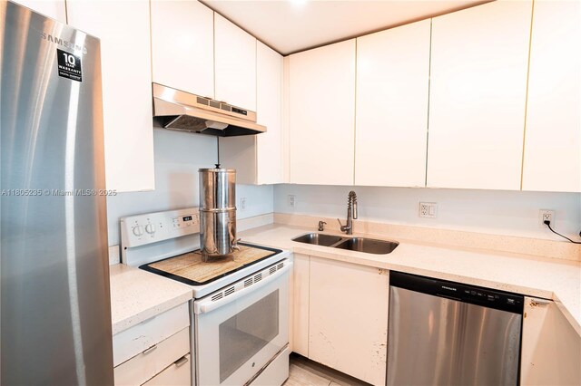 1817 S Ocean Dr Unit 0918, Hallandale Beach, FL 33009 - kitchen featuring stainless steel appliances, under cabinet range hood, a sink, light countertops, and white cabinets