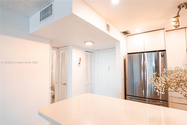 1817 S Ocean Dr Unit 0918, Hallandale Beach, FL 33009 - kitchen featuring freestanding refrigerator, white cabinets, and recessed lighting