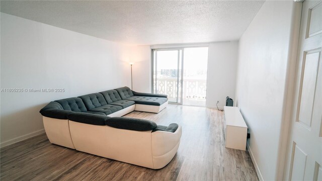 1817 S Ocean Dr Unit 0918, Hallandale Beach, FL 33009 - living room featuring wood finished floors, a textured ceiling, baseboards, and a wall of windows