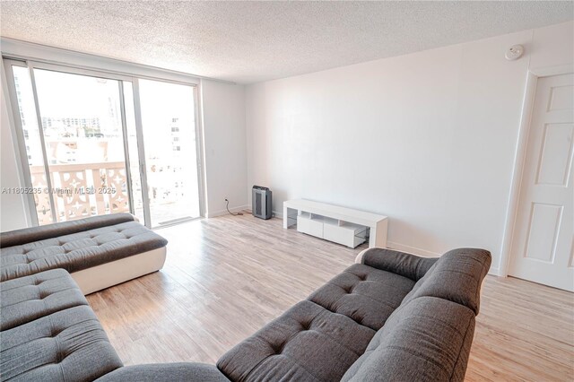 1817 S Ocean Dr Unit 0918, Hallandale Beach, FL 33009 - living room featuring a textured ceiling and wood finished floors