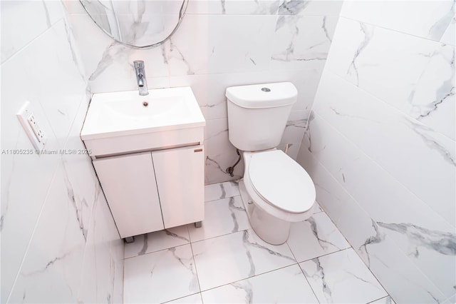 1817 S Ocean Dr Unit 0918, Hallandale Beach, FL 33009 - half bathroom featuring vanity, marble finish flooring, toilet, and tile walls