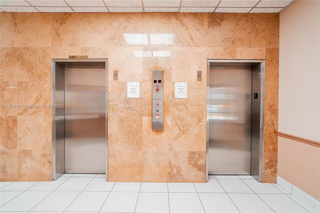 1817 S Ocean Dr Unit 0918, Hallandale Beach, FL 33009 - corridor featuring elevator, light tile patterned floors, a paneled ceiling, and tile walls