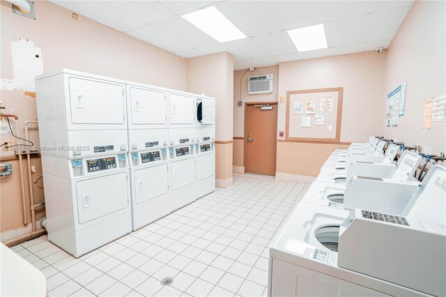 1817 S Ocean Dr Unit 0918, Hallandale Beach, FL 33009 - community laundry with stacked washer / drying machine, washer and dryer, a wall mounted AC, and light tile patterned flooring
