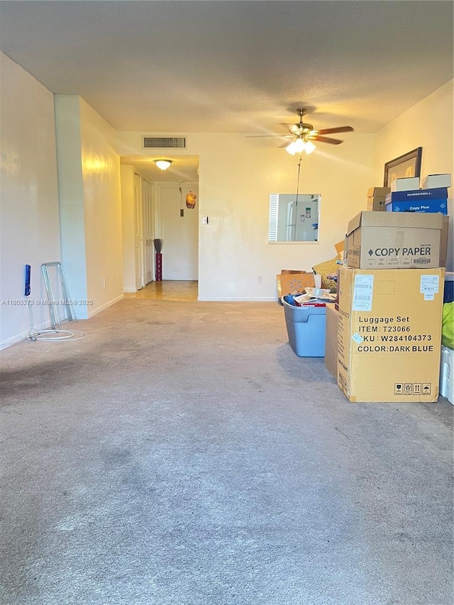 6071 NW 61st Ave Unit 311, Tamarac, FL 33319 - unfurnished living room with carpet floors, ceiling fan, and baseboards