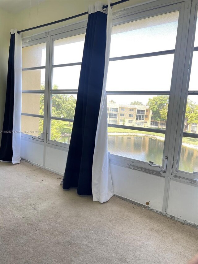 6071 NW 61st Ave Unit 311, Tamarac, FL 33319 - unfurnished room featuring carpet flooring and a water view