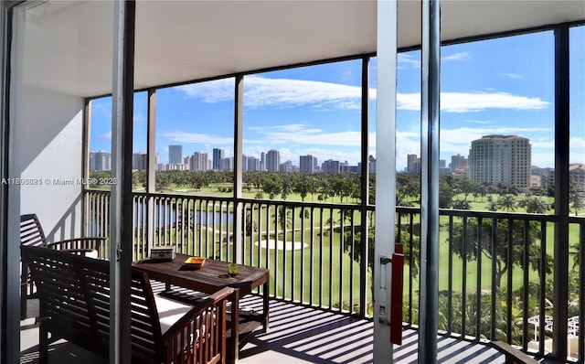 20379 W Country Club Dr Unit 836, Aventura, FL 33180 - sunroom / solarium featuring a skyline view, healthy amount of natural light, and a water view