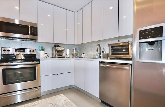 20379 W Country Club Dr Unit 836, Aventura, FL 33180 - kitchen with appliances with stainless steel finishes, modern cabinets, and white cabinetry