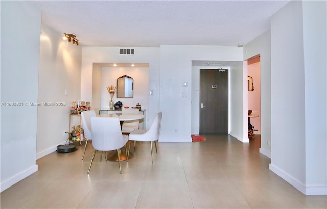 20379 W Country Club Dr Unit 836, Aventura, FL 33180 - tiled dining room featuring a textured ceiling and baseboards