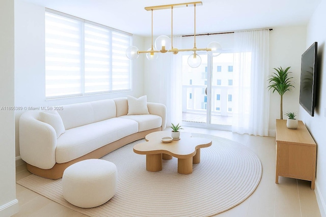 701 Collins Ave Unit 1F, Miami Beach, FL 33139 - living area with a chandelier and plenty of natural light