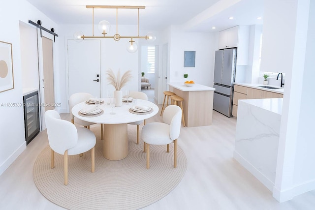 701 Collins Ave Unit 1F, Miami Beach, FL 33139 - dining area featuring a barn door, electric panel, beverage cooler, and light wood finished floors