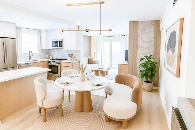 701 Collins Ave Unit 1F, Miami Beach, FL 33139 - dining room featuring plenty of natural light and light wood-style flooring
