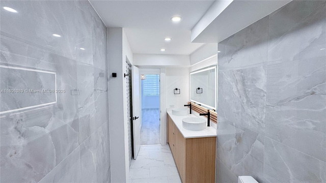701 Collins Ave Unit 1F, Miami Beach, FL 33139 - bathroom featuring marble finish floors, double vanity, and recessed lighting