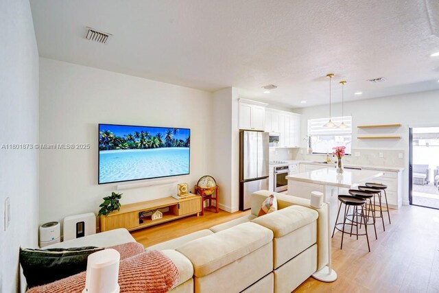 10602 W 33rd Way, Hialeah, FL 33018 - living area with light wood finished floors and recessed lighting