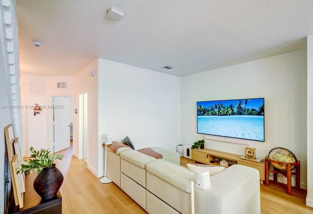 10602 W 33rd Way, Hialeah, FL 33018 - living area with light wood-type flooring and baseboards