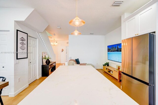 10602 W 33rd Way, Hialeah, FL 33018 - bedroom featuring freestanding refrigerator, light wood finished floors, baseboards, and a chandelier