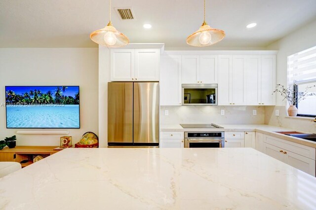 10602 W 33rd Way, Hialeah, FL 33018 - kitchen with appliances with stainless steel finishes, light stone countertops, hanging light fixtures, and recessed lighting