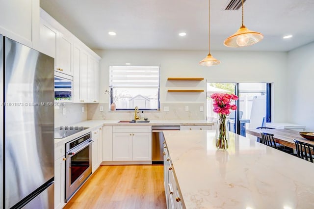 10602 W 33rd Way, Hialeah, FL 33018 - kitchen featuring appliances with stainless steel finishes, a sink, plenty of natural light, light wood-style flooring, and recessed lighting
