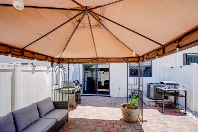 10602 W 33rd Way, Hialeah, FL 33018 - view of patio / terrace featuring a gazebo, outdoor lounge area, and central AC unit