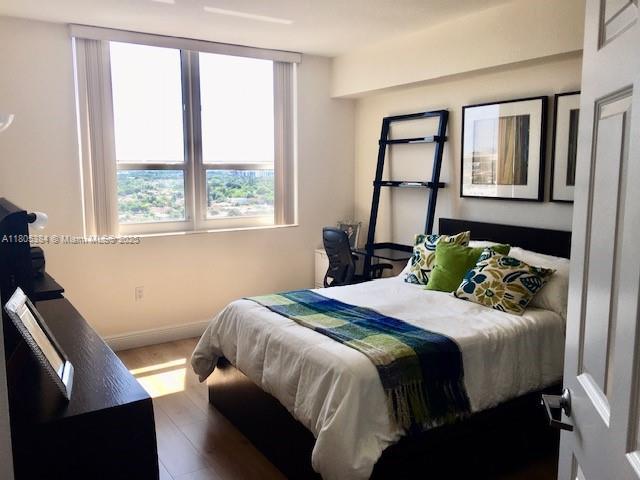 3232 SW 22nd Ter Unit 1303, Miami, FL 33145 - bedroom with baseboards and wood finished floors