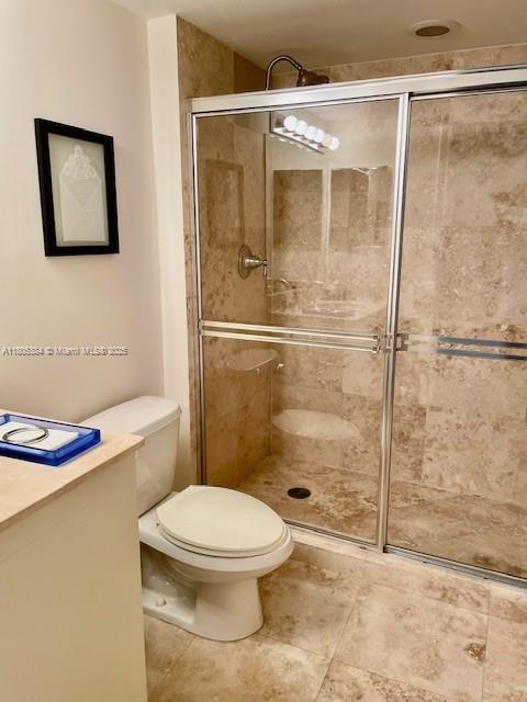 3232 SW 22nd Ter Unit 1303, Miami, FL 33145 - full bath featuring a shower stall, toilet, and tile patterned floors