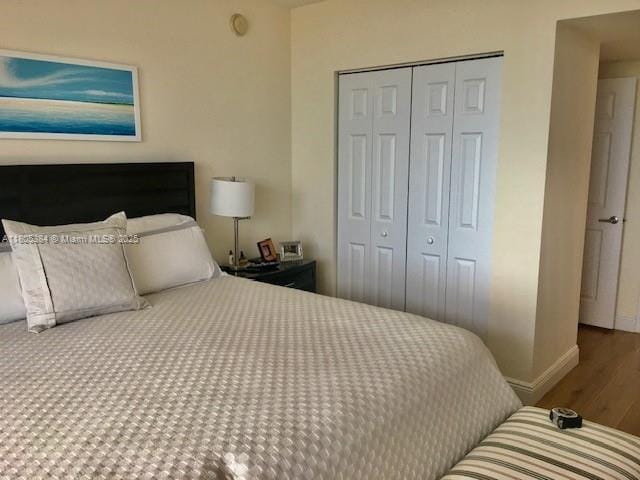 3232 SW 22nd Ter Unit 1303, Miami, FL 33145 - bedroom featuring wood finished floors, a closet, and baseboards