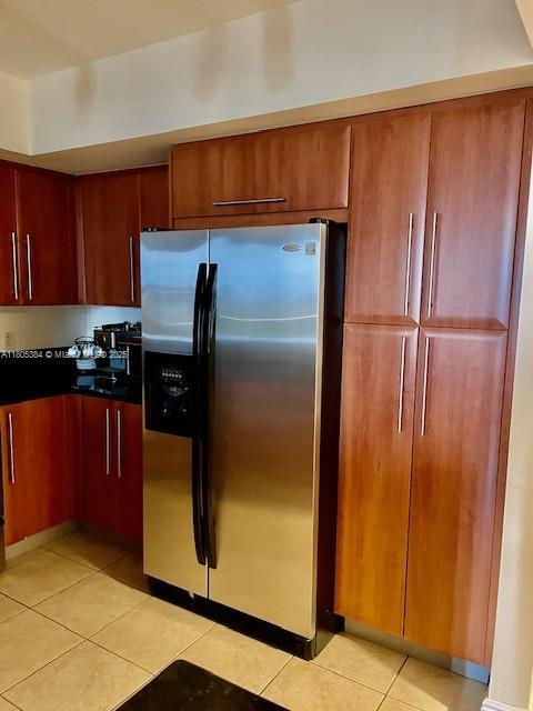 3232 SW 22nd Ter Unit 1303, Miami, FL 33145 - kitchen featuring stainless steel refrigerator with ice dispenser, light tile patterned flooring, and dark countertops